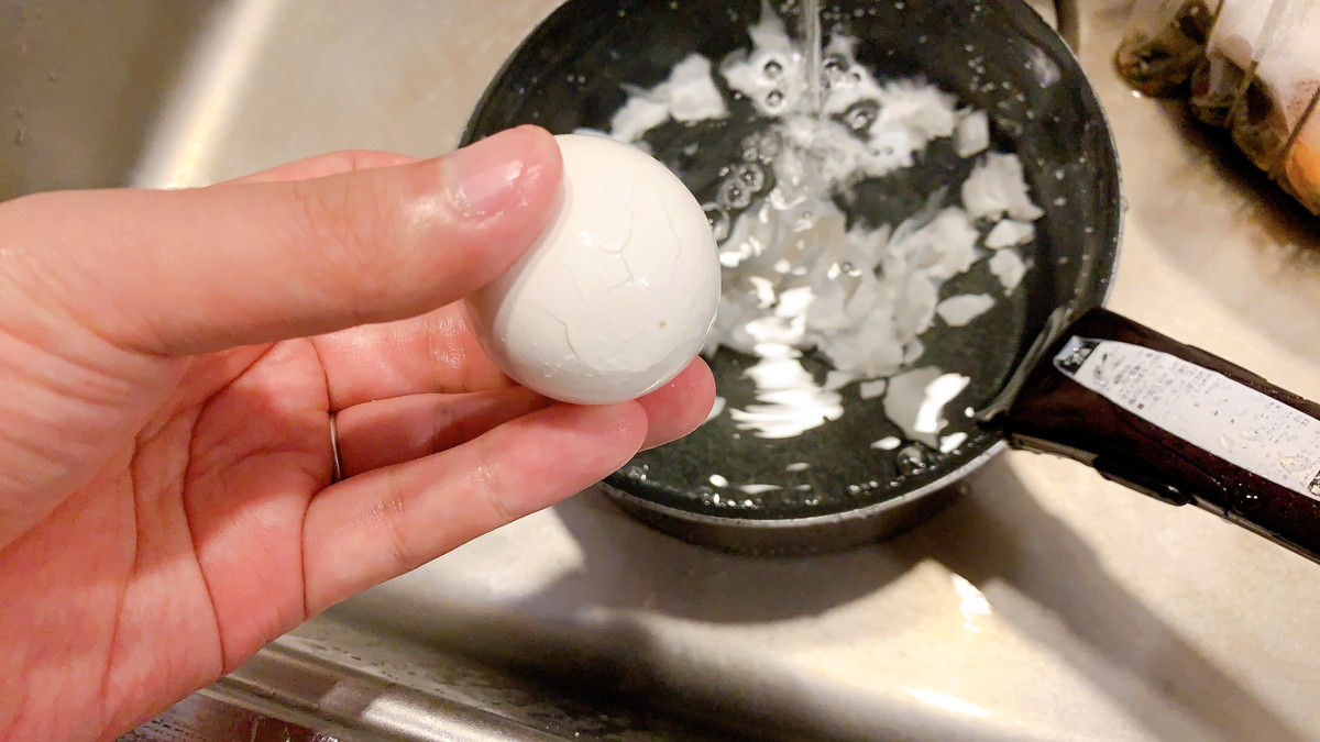 流水に当てながらゆで卵の殻をむく